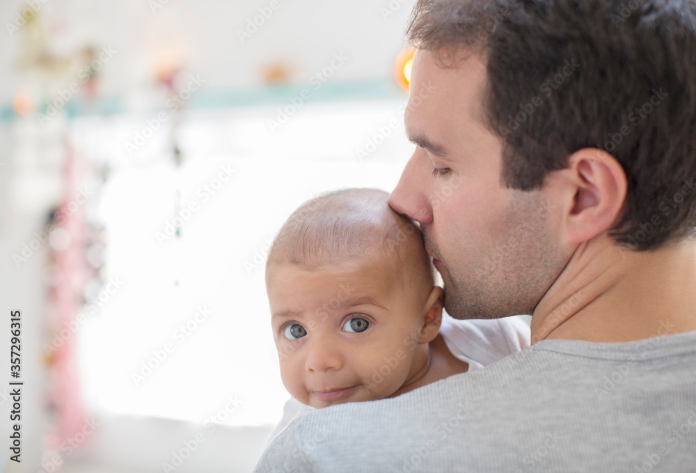 Father kissing baby boy