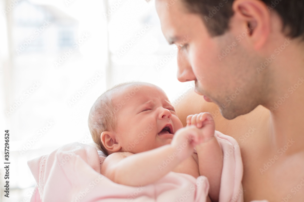 Father comforting crying baby girl Father comforting crying baby girl