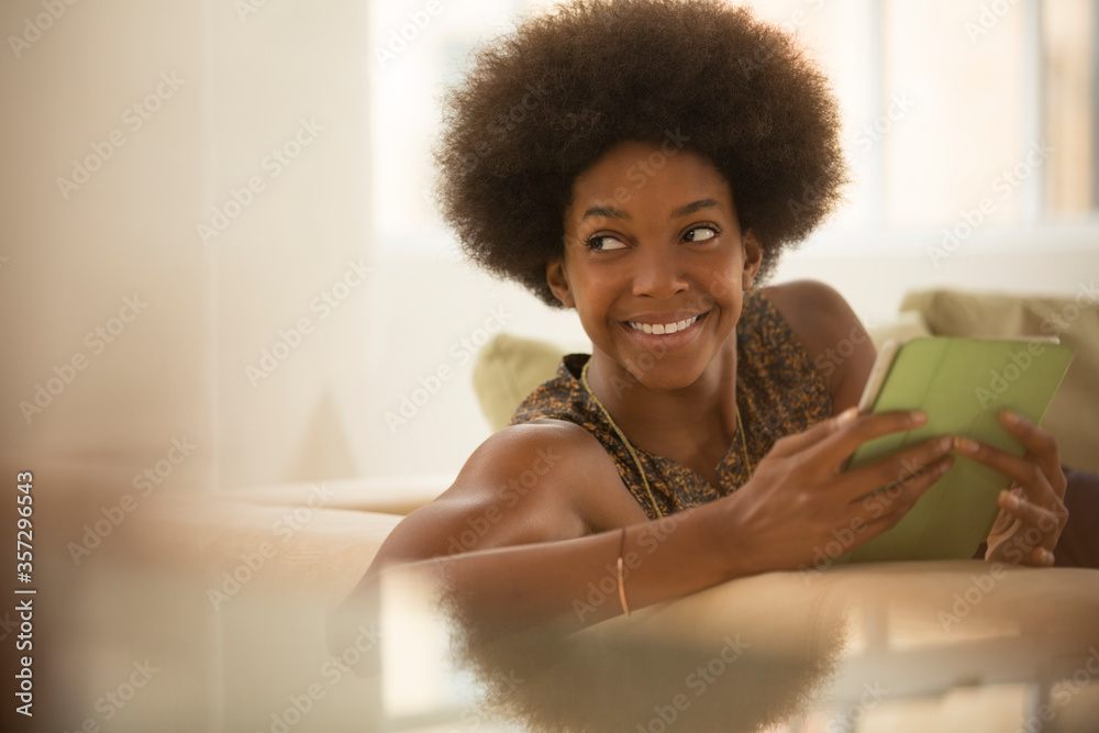 Woman using digital tablet on sofa Woman using digital tablet on sofa