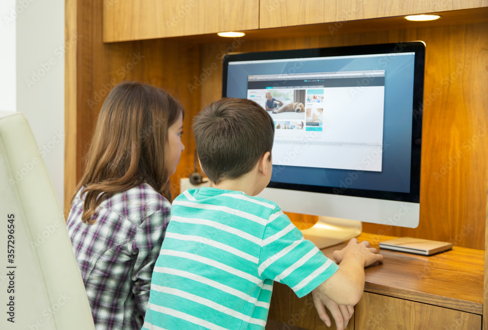 Children using computer together Children using computer together