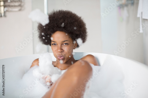 Woman playing with bubbles in bath