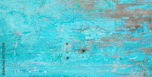 Old crackled painted wood surface. Vintage wooden wall or floor with cracked paint.