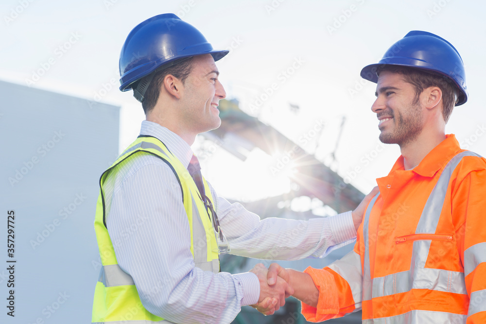 Businessman and worker handshaking Businessman and worker handshaking