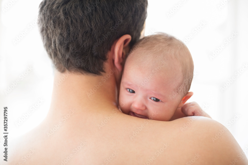 Man comforting crying baby girl Man comforting crying baby girl
