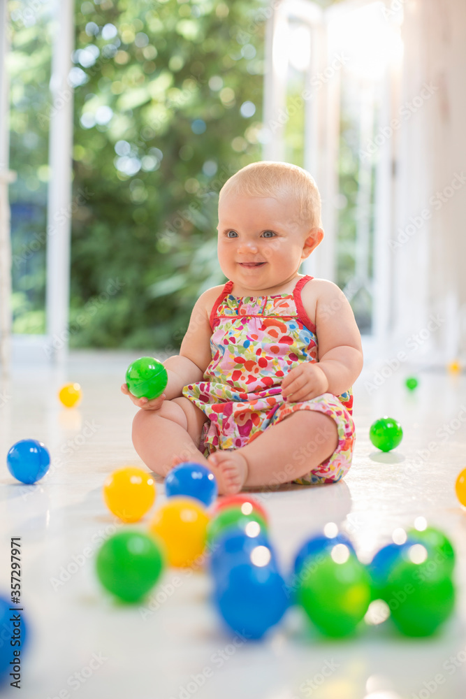 Baby girl playing with toys on floor Baby girl playing with toys on floor