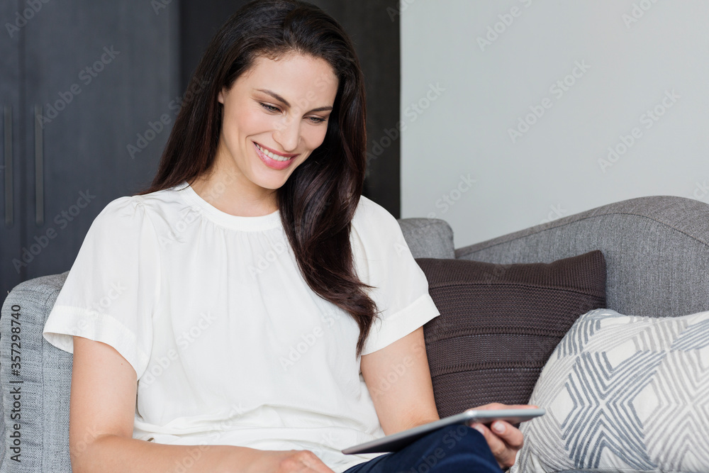Smiling woman using digital tablet Smiling woman using digital tablet
