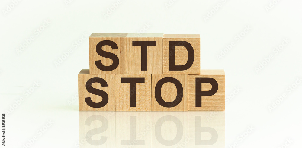 STOP STD Sexually transmitted infections text on wooden cubes. Medical concept STOP STD Sexually transmitted infections text on wooden cubes. Medical concept