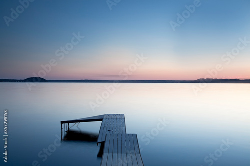 Fototapeta Naklejka Na Ścianę i Meble -  Dock over still lake, Saratoga Lake, New York, United States