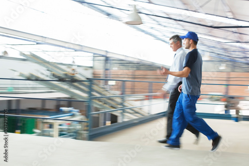 Wallpaper Mural Supervisor and worker walking in food processing plant Torontodigital.ca
