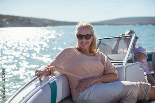 Older woman sitting in boat on water © Paul Bradbury/KOTO