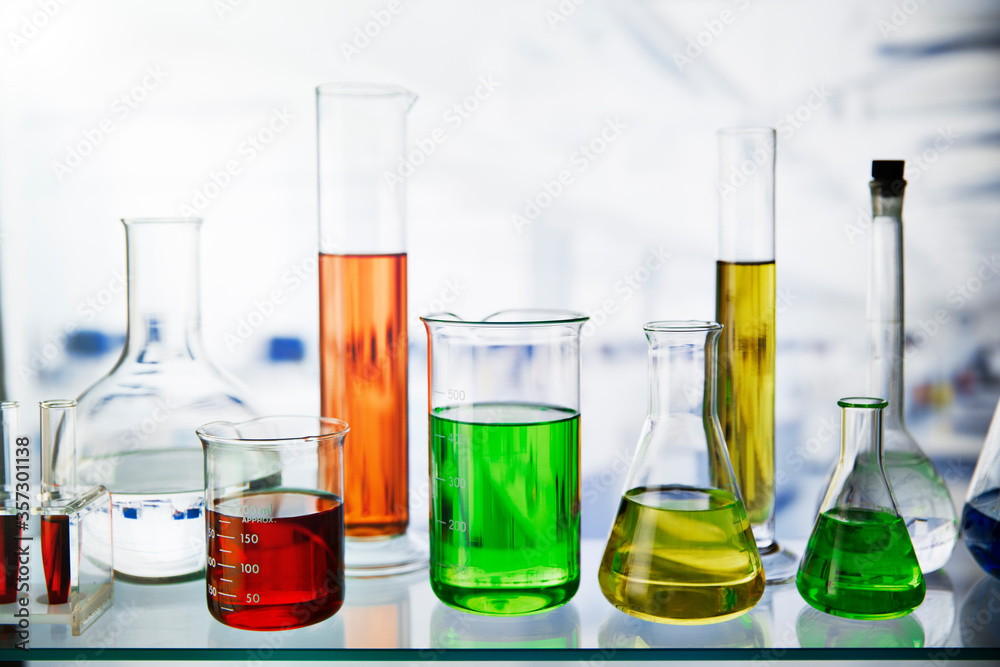 Beakers of various solutions on shelf in lab Beakers of various solutions on shelf in lab