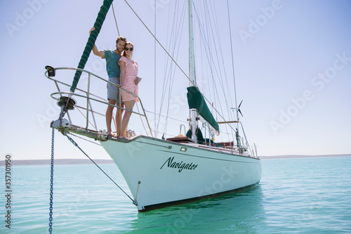 Couple standing on front of boat 