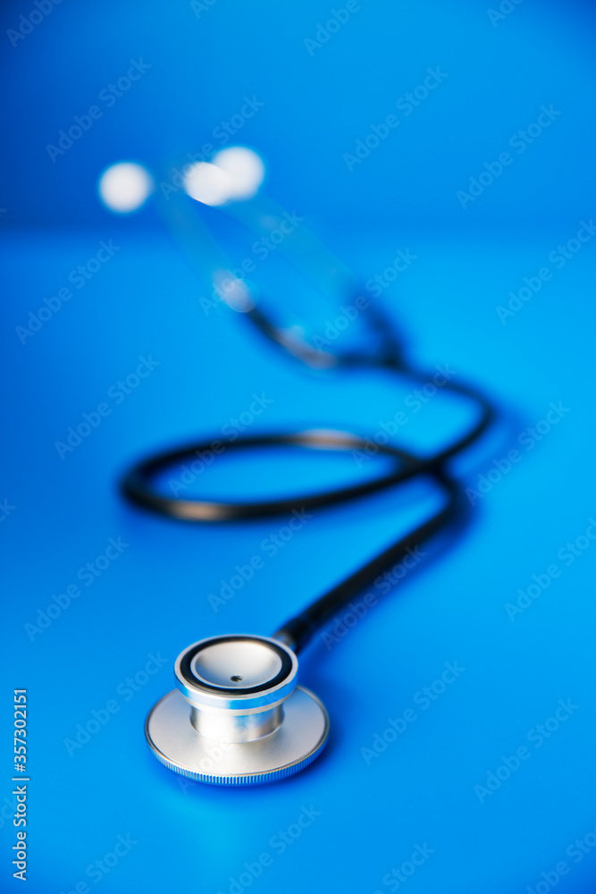 Close up of stethoscope on blue counter Close up of stethoscope on blue counter