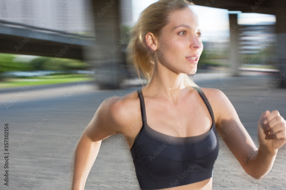 Woman running through city streets