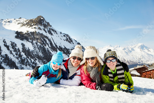 Family laying in the snow together