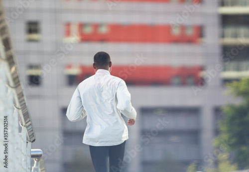 Man running through city street 