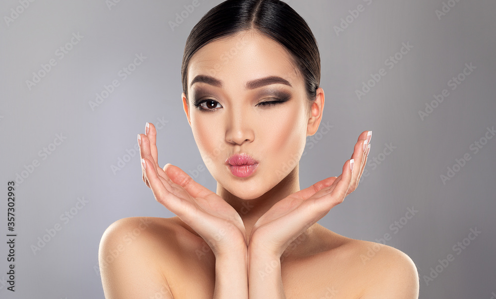 Fototapeta premium Beautiful young asian woman with Clean Fresh Skin on face . Oriental girl Facial treatment . Cosmetology , beauty and spa . Skin care. Chinese and Japanese cosmetics