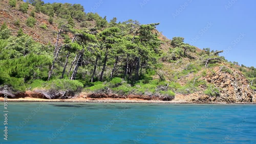 Blue voyage cruise in Turkey. Sailing along Bodrum, Marmaris, Datca, Fethiye shores. Wild and beautiful Mediterranean Sea with pine trees on the coast. 
