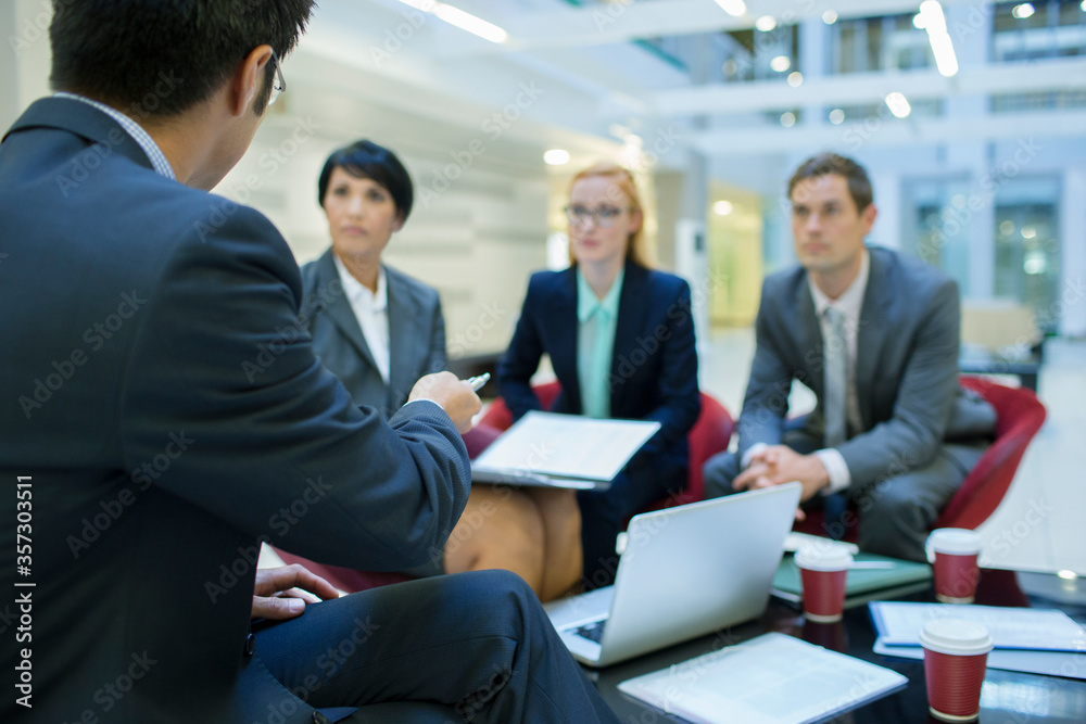 Business people talking in meeting in office building Business people talking in meeting in office building