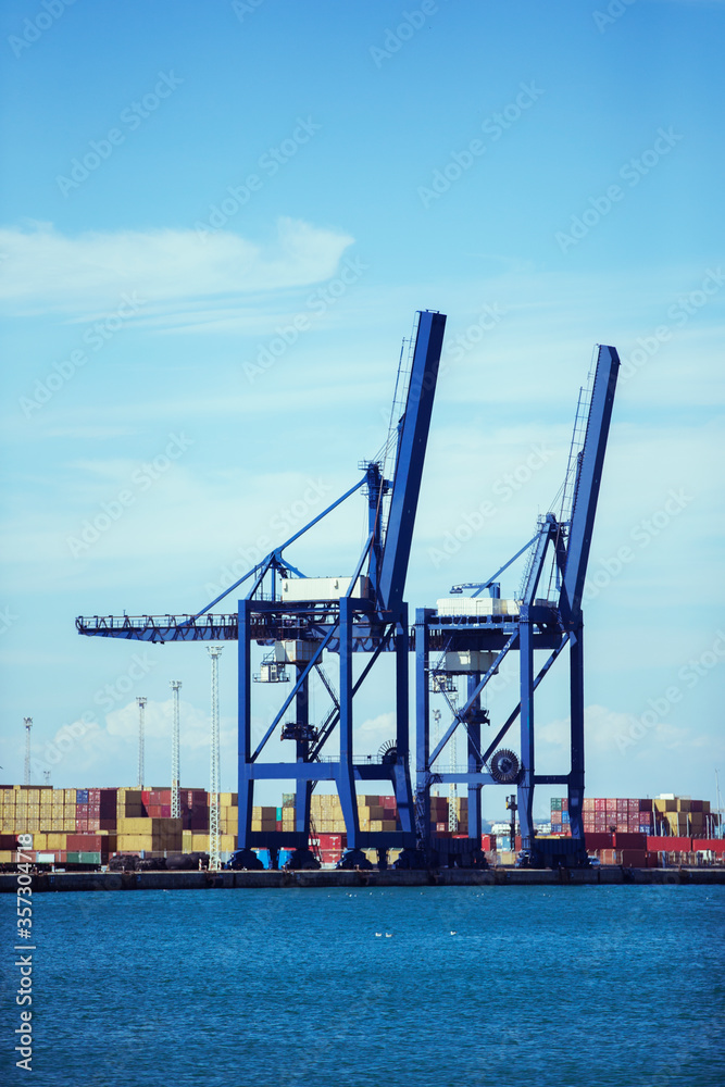 Cranes and cargo containers at waterfront