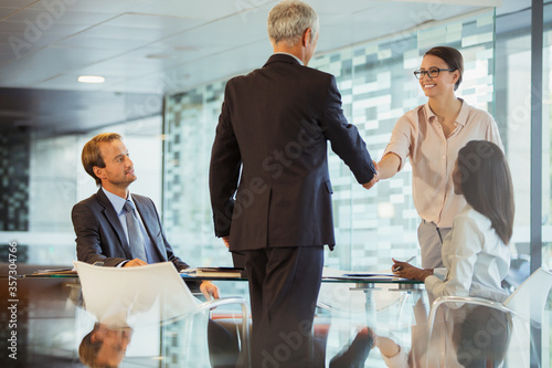 Business people shaking hands in office building
