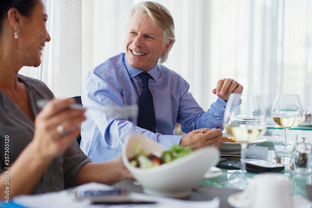 Smiling business people having lunch in restaurant Smiling business people having lunch in restaurant