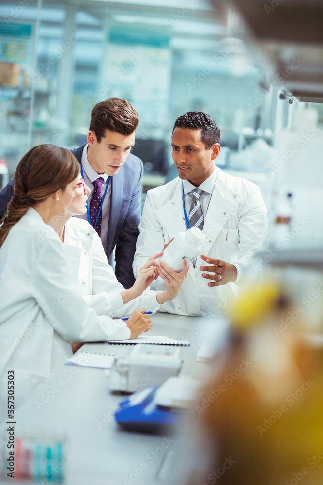Fototapeta premium Scientists and businessman talking in laboratory