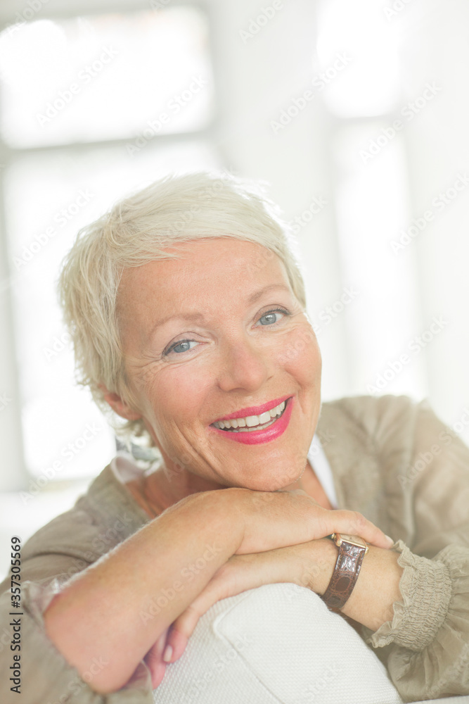 Older woman smiling on sofa Older woman smiling on sofa