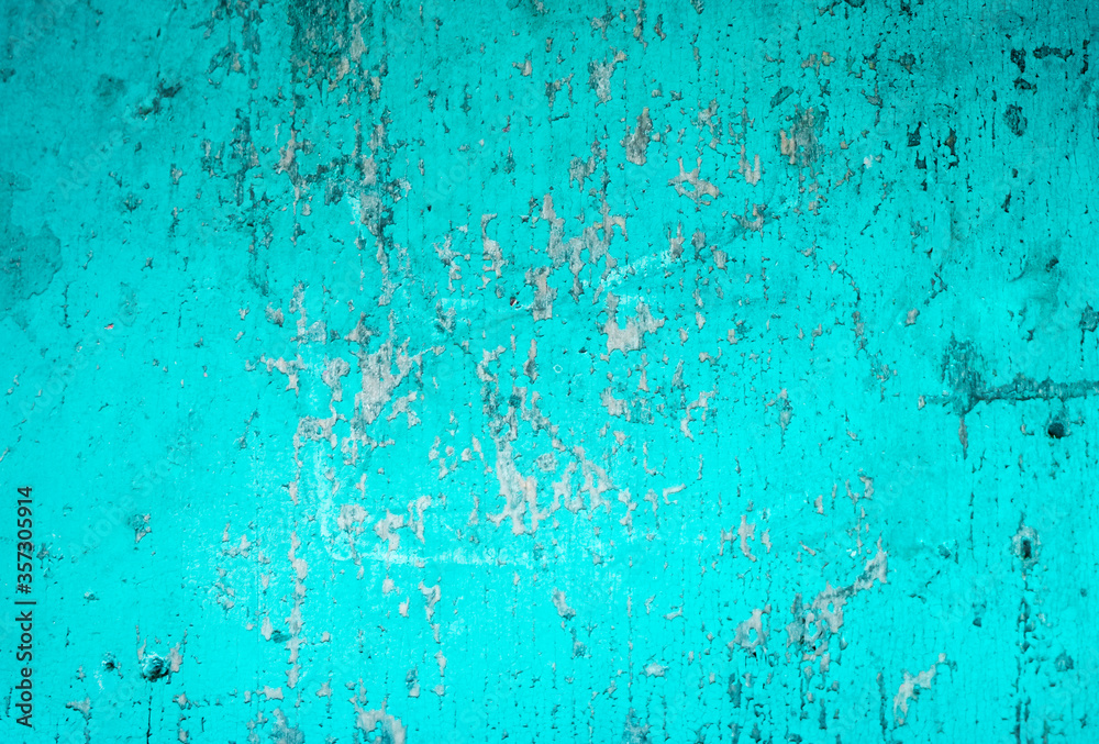 Cracked painted blue teal background with texture and grunge finish