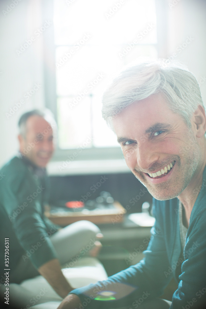 Gay couple relaxing together with record player Gay couple relaxing together with record player