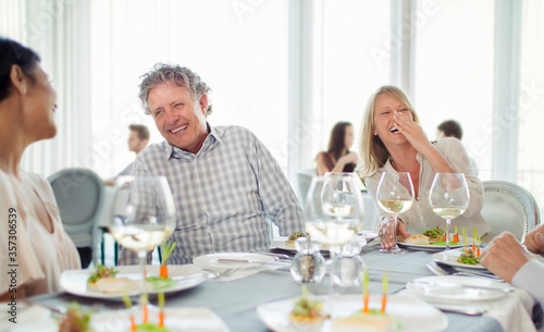 Cheerful people laughing at restaurant table