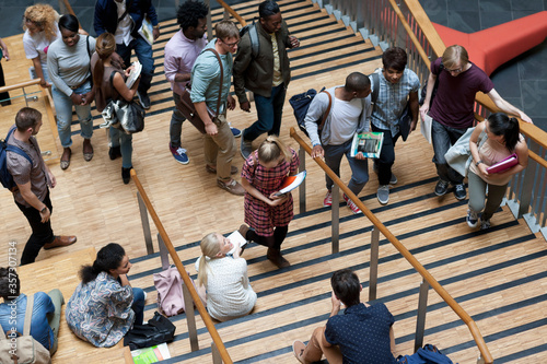 Elevated view of university students walking up and down stairs photo