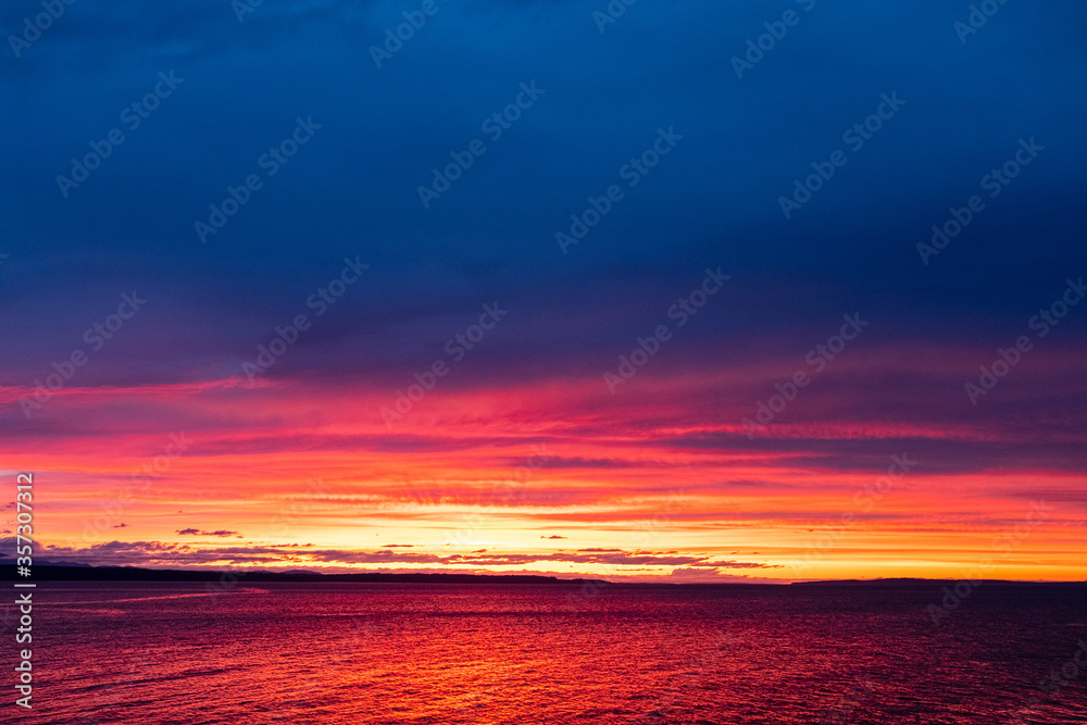 The golden rays of sunset over the ocean water