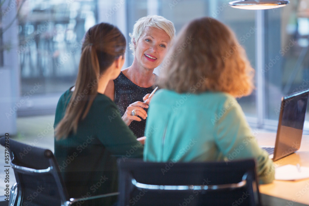 Businesswomen talking in office meeting Businesswomen talking in office meeting