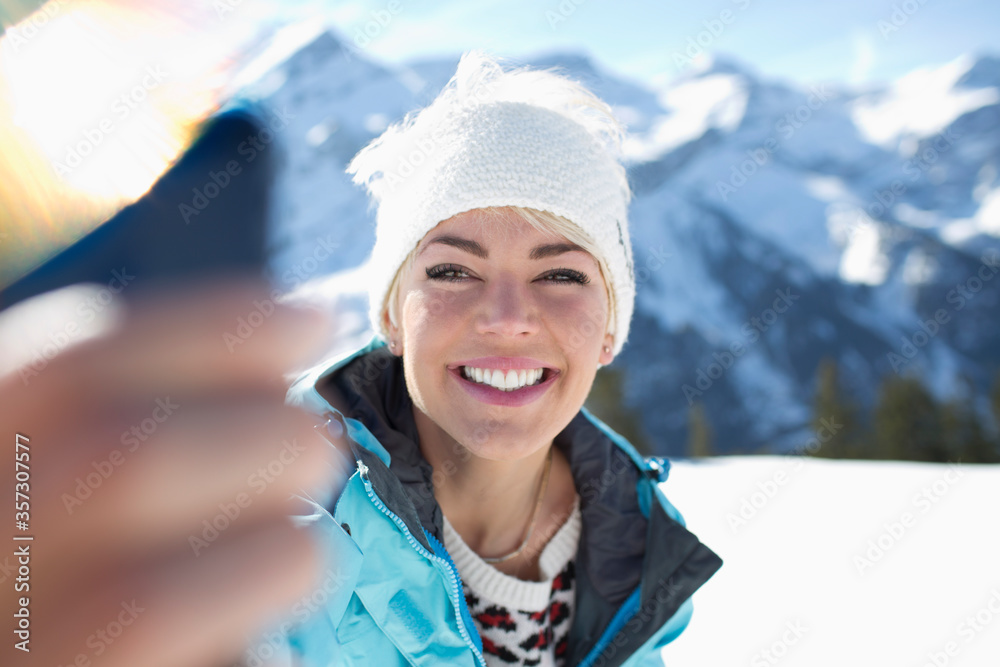 Smiling woman taking selfie in snow Smiling woman taking selfie in snow