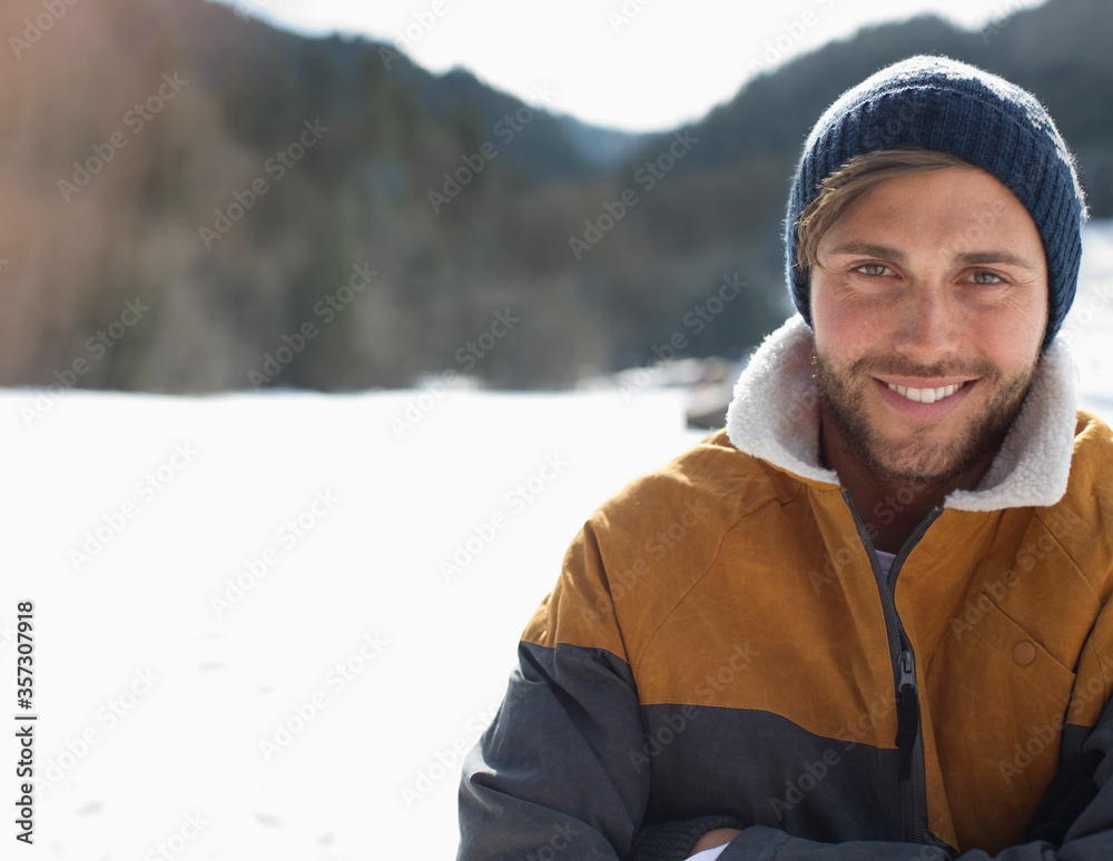 Portrait of smiling man in snow