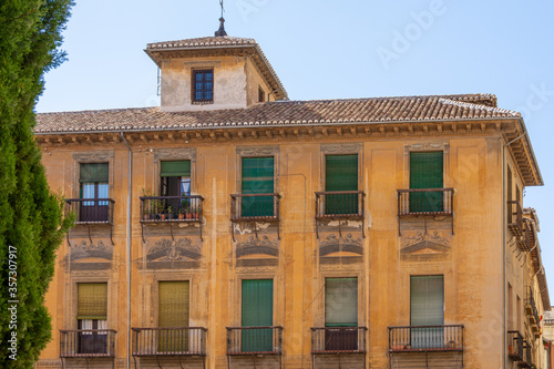 Old building with shutters on the balconies in the Plaza de Las Pasiegas next to the Cathedral of Granada