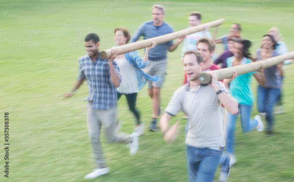 Teams racing with logs in field