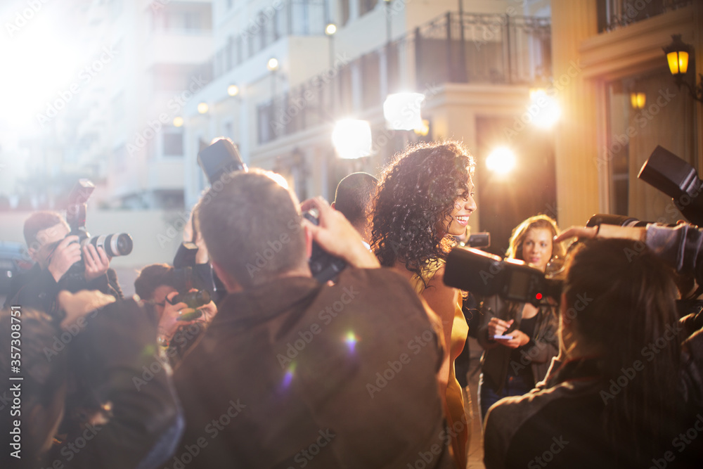 Paparazzi photographing celebrity at event