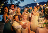 Wedding guests toasting champagne during wedding reception in garden