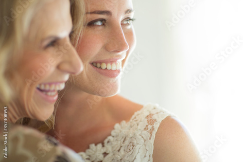 Valokuva Matron of honor and bride smiling in domestic room