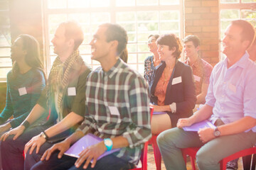 Audience smiling in community center