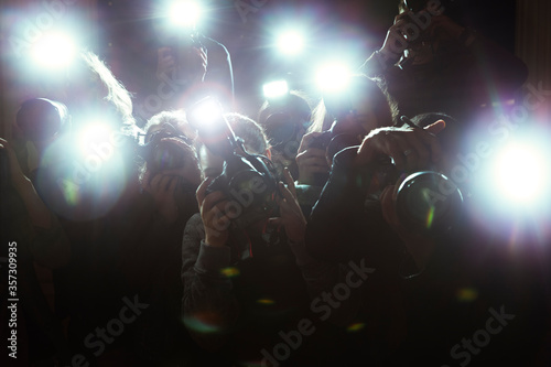 Close up of paparazzi photographers pointing cameras photo