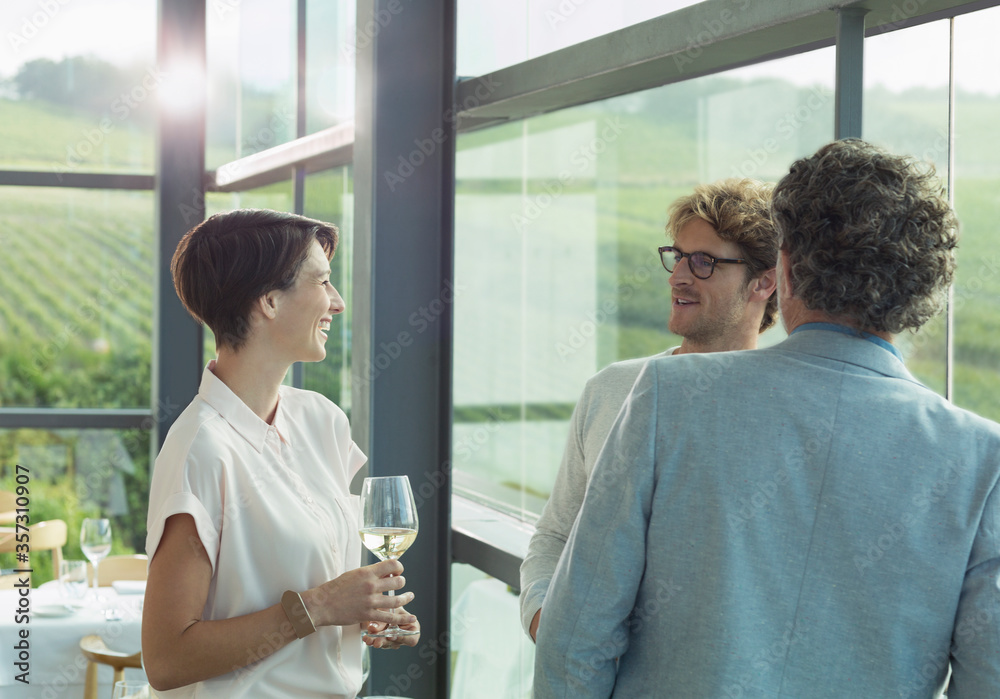 Friends drinking white wine in winery tasting room Friends drinking white wine in winery tasting room