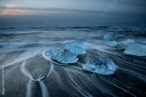 Long exposure of ice on cold stormy ocean beach, Jokulsarlon, Iceland