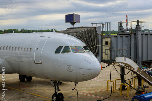 Front view of landed airplane in a terminal of at the International Airport