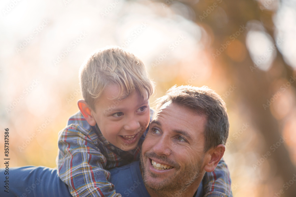 Affectionate father and son piggybacking Affectionate father and son piggybacking