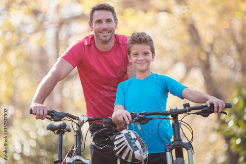 Portrait father and son bike riding 