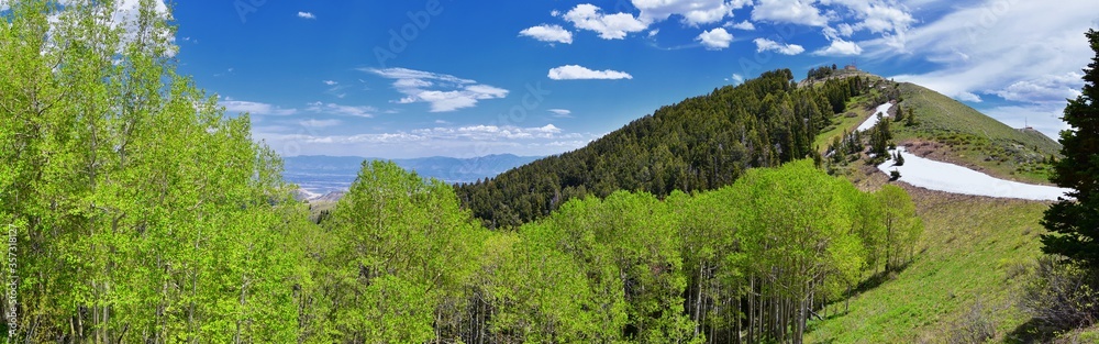 Rocky Mountain Wasatch Front peaks, panorama landscape view from Butterfield Canyon Oquirrh range toward Provo, Tooele Utah Lake by Rio Tinto Bingham Copper Mine, Great Salt Lake Valley in spring. Uta Rocky Mountain Wasatch Front peaks, panorama landscape view from Butterfield Canyon Oquirrh range toward Provo, Tooele Utah Lake by Rio Tinto Bingham Copper Mine, Great Salt Lake Valley in spring. Uta