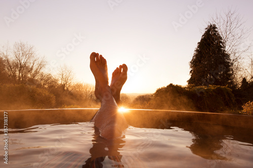 Man‚Äôs feet raised out of pool